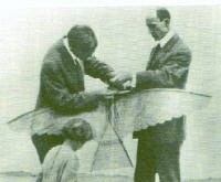 Wright Brothers fixing a kite